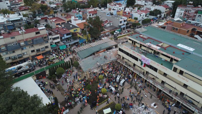 Mexican rescue teams look for people trapped in the rubble at the Enrique Rebsamen elementary school in Mexico City on September 20, 2017. 
At least 21 children were killed and about 30 children are still missing at the Enrique Rebsamen elementary school that collapsed in the Mexican capital as rescue efforts are still underway after a powerful earthquake that has killed 217 people.
 / AFP PHOTO / MARIO VAZQUEZ        (Photo credit should read MARIO VAZQUEZ/AFP/Getty Images)