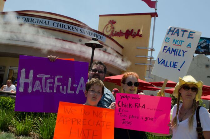 Familes as well as individuals attended. Here Gary Lucy, Jane Wilson, and son, Preston Lucy, all came to the protest. Fellow protester Kris McGaha joins them.