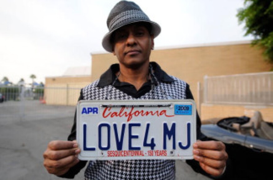 Fan Demarco DeLeon shows of his 'Love4MJ' license plate on the street near Glendale Forest Lawn Memorial Park on September 3, 2009 in Glendale, California.