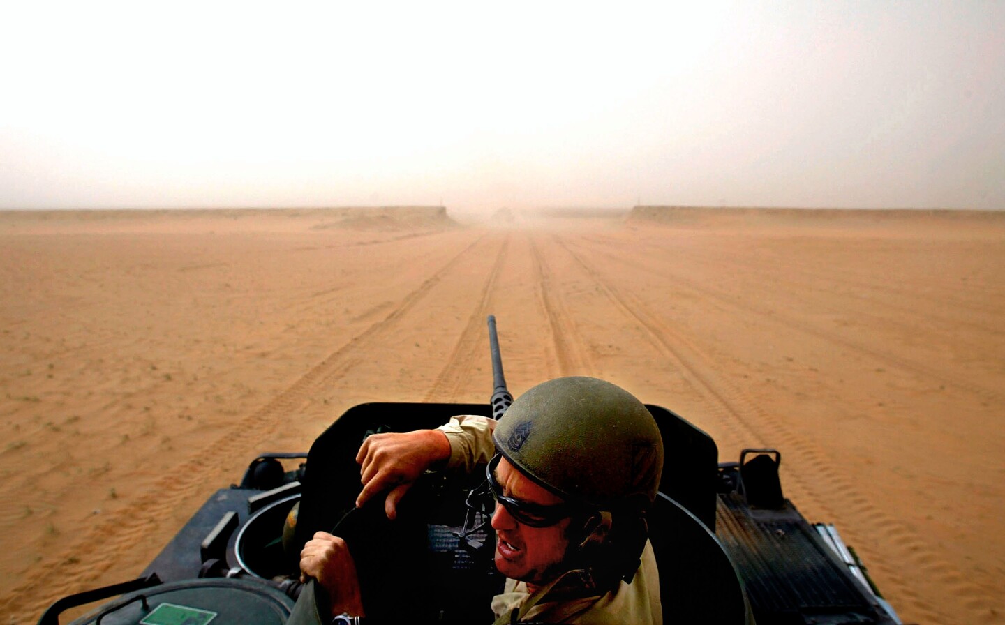 1SG Michael "Todd" Hibbs sits on his 113 Vehicle with A Company 1-30 Infantry, 1st Brigade Combat Team 3rd Infantry Division of the U.S. Army from Fort Benning Ga. as he prepares to cross into the DMZ between Iraq and Kuwait Wednesday March 19, 2003. 