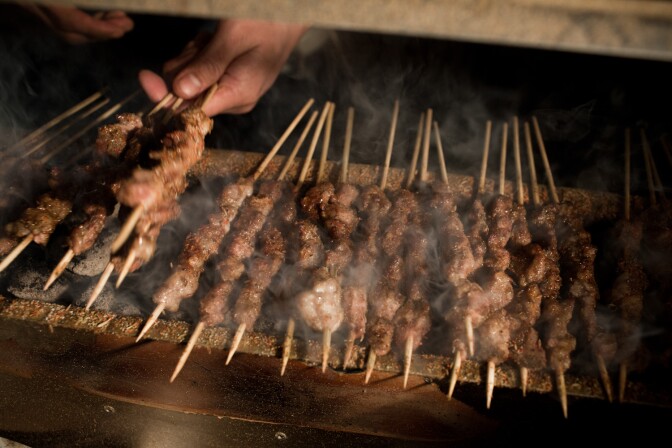  The Kebab Brothers prepare lamb kebabs with cumin and charcoal.