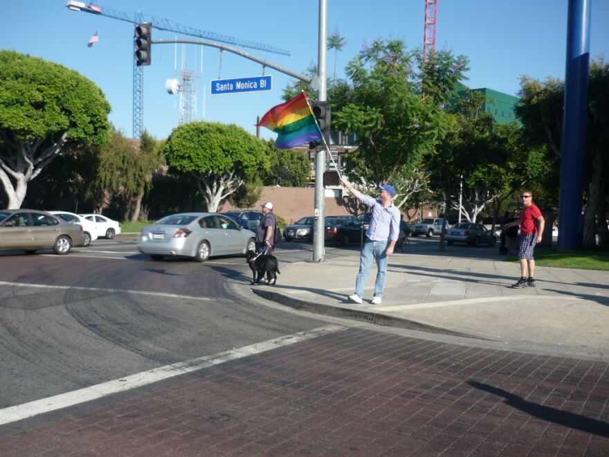 John Trover waves a rainbow flag in West Hollywood on Aug. 4, 2010, to celebrate federal court Judge Vaughn Walker's decision to overturn Prop 8.  