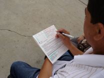 An eligible voter fills out a form outside  St. Joseph’s Catholic church in Hawthorne, where parishioners set up a registration table Sunday.