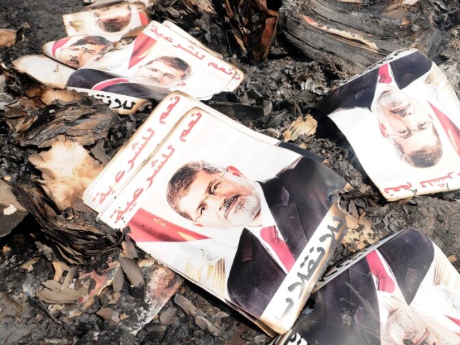 Posters of ousted Egyptian President Mohammed Morsi amid the rubble of a protest camp in Cairo after Wednesday's crackdown by government forces.