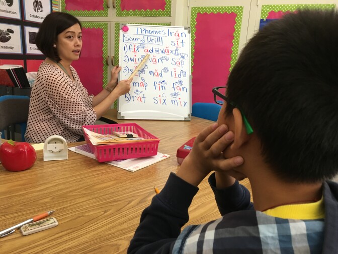 San Gabriel teacher Jenny Tan helps a student who's been in the U.S. less than a year learn the basics of English. 
