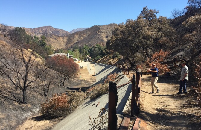 LA County Department of Public Works civil engineer Mike Miranda checks out a debris basin with Shadow Hills resident David Schneider. Debris basins protect foothill neighborhoods from dangerous mudflows.