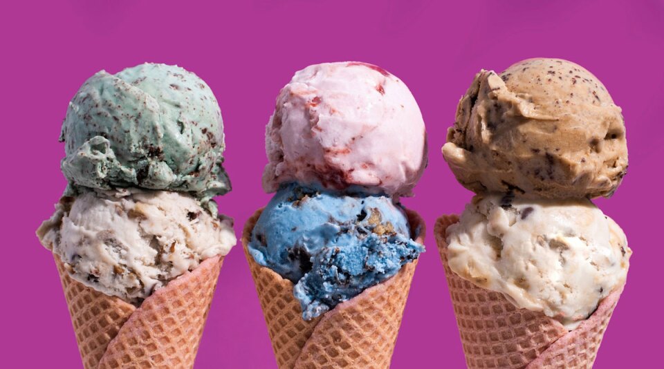 three double-scoop ice cream cones stand against a purple background