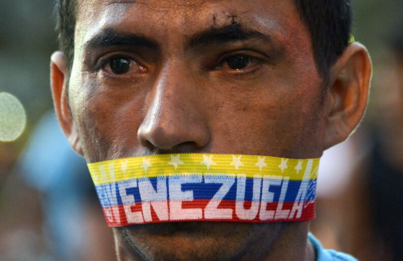 A man attends a protest against the government of Venezuelan President Nicolas Maduro in Caracas on February 23, 2014. A total of 25 people were injured overnight during clashed between opposition groups and police in eastern Caracas. On Saturday the lasgest opposition rally had taken place after almost three weeks of students protests, which left ten people killed.