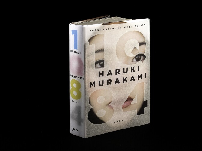 <strong><em>1Q84</em></strong><strong> by Haruki Murakami</strong>: "This epic, complex story begins when a woman named Aomame in 1984 Tokyo has a revelation that she has entered a universe parallel to our own. She calls it 'Q' for question, and in Japanese, Q rhymes with 9. I wanted to represent these two planes of existence with the book's jacket and its paper binding underneath."