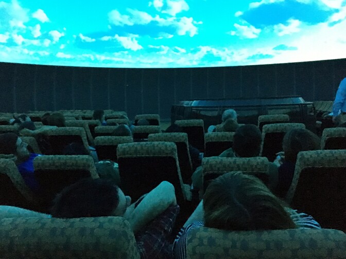 Fans lean back and enjoy the show at the Samuel Oschin Planetarium.