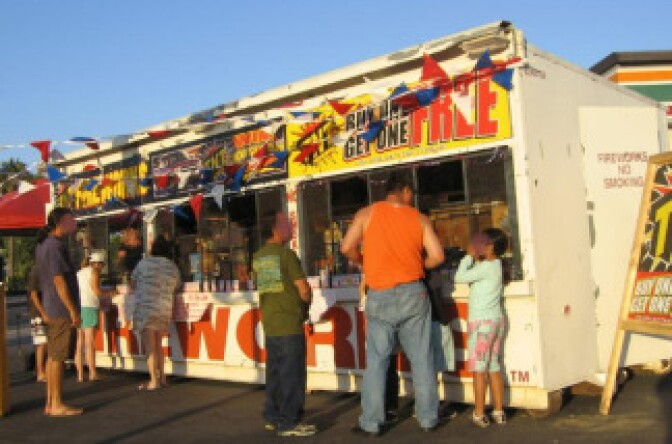 People buying "safe and sane" fireworks from a stand in Costa Mesa. File photo. 