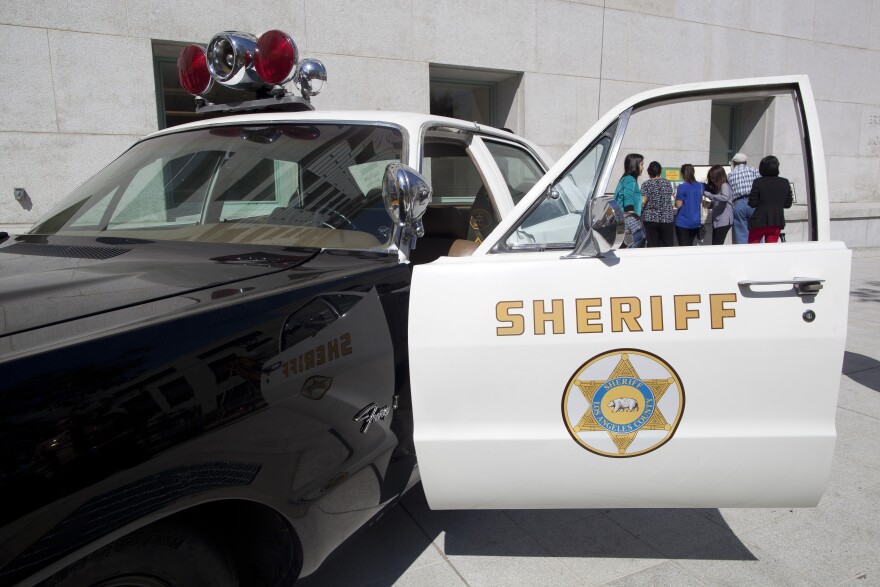 An old Los Angeles County Sheriff vehicle is parked outside of the Hall of Justice during the opening ceremony.