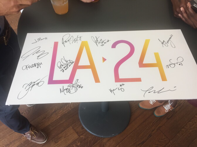 File: Signing off on L.A. 24: Athletes signed a placard before the U.S. Olympic Committee named Los Angeles the bid city for the 2024 Olympic Games 