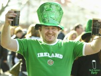 File: A man poses with Irish beer during St Patrick's Day celebrations March 16, 2003 in London. 