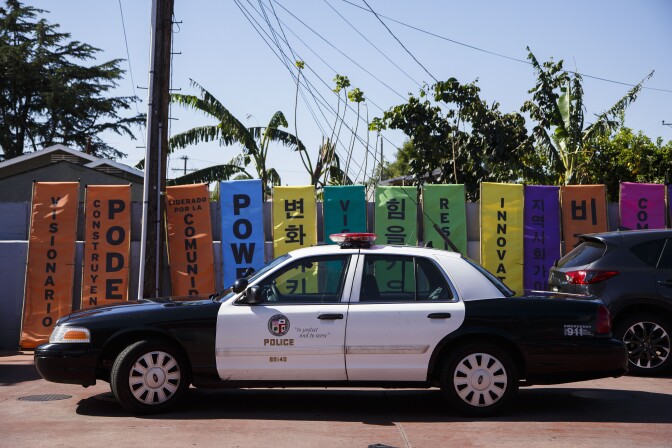 LOS ANGELES, CA - APRIL 29: An LAPD vehicle is parked next to protest banners written in Korean and English for a peace rally to mark the 25th anniversary of the LA riots, at the intersection of Florence and Normandie, on April 29, 2017 in Los Angeles, California. Florence and Normandie was the flashpoint for the riots that was sparked by the police acquittals in the Rodney King beating. (Photo by Warrick Page/Getty Images)