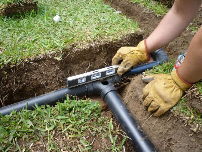 Branched drain system: Someone levels the flow splitter. 