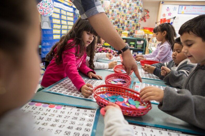 Students in a transitional kindergarten classroom at the Martha Escutia Primary Center play the hundred board game. Instead of entering kindergarten at a younger age, these kids get an extra year to learn new skills and prepare for kindergarten.