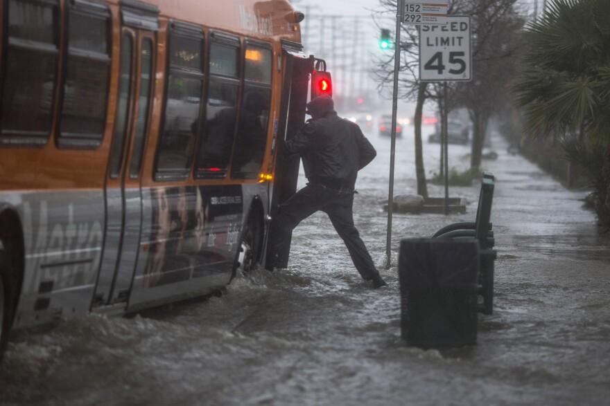 SUN VALLEY, CA - FEBRUARY 17: A man boards a bus on a flooded street as a powerful storm moves across Southern California on February 17, 2017 near Sun Valley, California. After years of severe drought, heavy winter rains have come to the state, and with them, the issuance of flash flood watches in Santa Barbara, Ventura and Los Angeles counties, and the evacuation of hundreds of residents from Duarte, California for fear of flash flooding from areas denuded by a wildfire last year.   (Photo by David McNew/Getty Images)