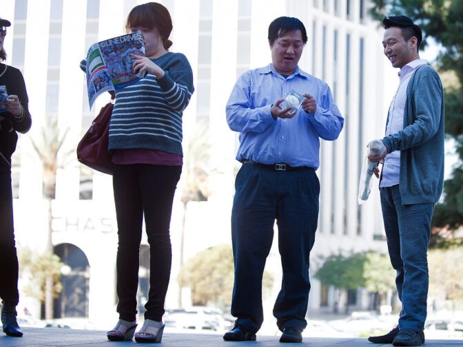Thomas Ji, left, of Belltower and Roy Schin of Los Angeles brought a baseball and bat for Hyun-Jin Ryu to sign. Ryu signed memorabilia and took photos with fans from noon to 1 p.m. on Tuesday.
