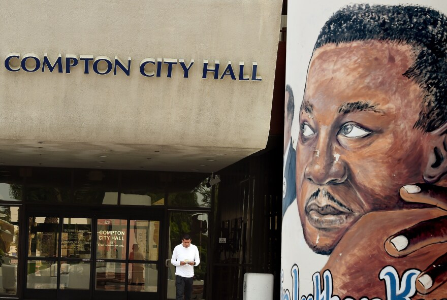 A man walk past a mural of Martin Luther King, Jr. outside the City Hall in Compton.