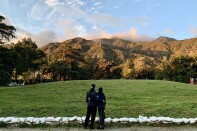 A couple, with their backs turned to the camera, look at the foothills surrounding Altadena. 