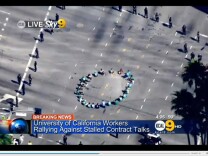 Hundreds gathered on Friday afternoon to protest over a contract dispute with the University of California, according to KCAL9. Several protesters sat down in a circle in the middle of the busy intersection of Wilshire and Westwood boulevards.