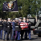 HOUSTON, TEXAS - DECEMBER 03:  Joint services military honor guard carry the flag-draped casket of the remains of President George H.W. Bush during a departure ceremony to Washington D. C at Ellington Field on December 3, 2018 in Houston, Texas. Bush, who died on November 30, will lie in state in Washington before returning to Houston for his funeral on Thursday.  (Photo by David J. Phillip - Pool/Getty Images)