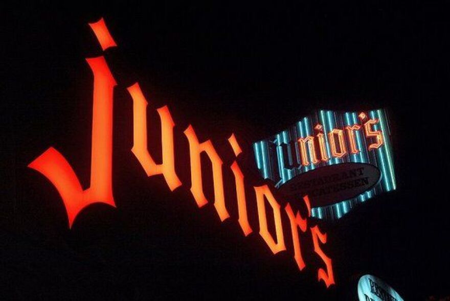 The sign for Junior's Deli in Westwood, Calif. lit up at night.