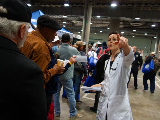 Janel Gehrke directs veterans at the Los Angeles Stand Down event to free acupuncture services.