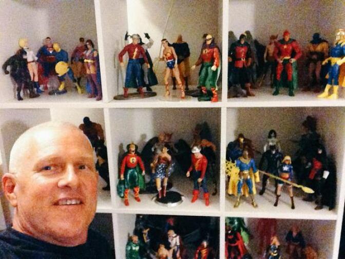 L.A. City Councilman Mike Bonin in front of just part of his collection of superheroes at his home (Twitter)