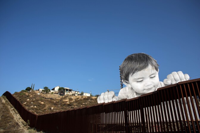 TOPSHOT - View of an artwork by French artist JR on the US-Mexico border in Tecate, California, United States on September 6, 2017, / AFP PHOTO / GUILLERMO ARIAS        (Photo credit should read GUILLERMO ARIAS/AFP/Getty Images)