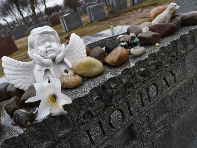 The gravestone of jazz singer and songwriter Billie Holiday is viewed March 25, 2015 at Saint Raymond's Cemetery in New York. Billie Holiday died with just $50 to her name taped to her thigh, but on the 100th anniversary of her birth the jazz legend is enjoying a renaissance as a trailblazer for generations of singers. Holiday was broken down by heroin use, police harassment and a husband who would beat her so severely she would tape her ribs before concerts.