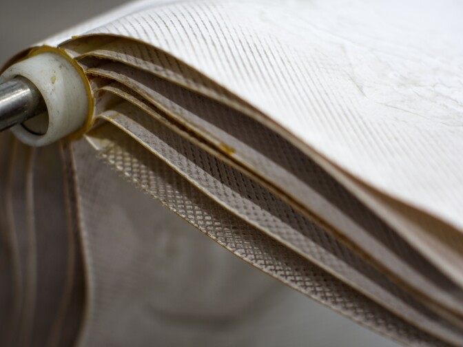 Reverse osmosis membrane sheets are unfolded and on display for tours. Silicone helps keep the membranes moist.