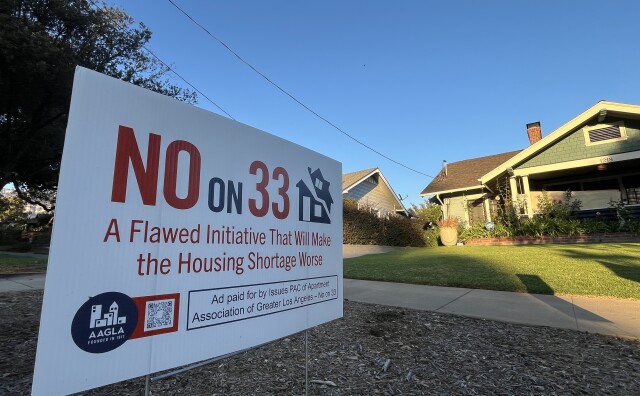 A "No on 33" sign is planted in front of a craftsman home.