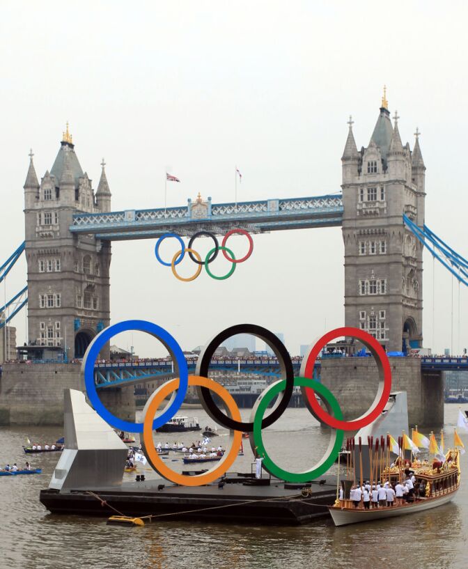 Torchbearer 018 Amber Charles stands underneath the giant Olympic Rings on the River Thames outside City Hall during Day 70 of the London 2012 Olympic Torch Relay on July 27, 2012 in London.