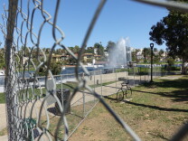 Image of a chain link fence that surrounds the perimeter of Echo Park Lake.