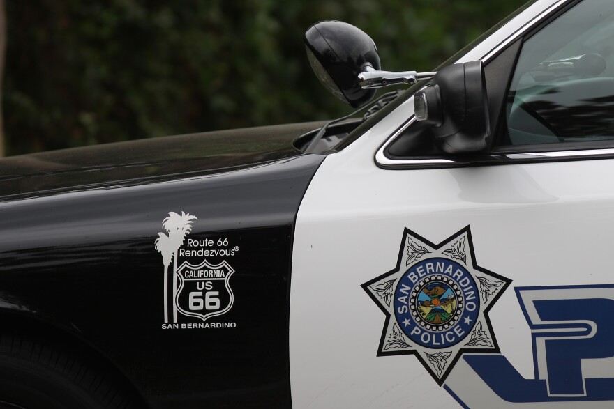 A close up shot of a patrol car has the seven point star and shield of the San Bernardino Police Dept.