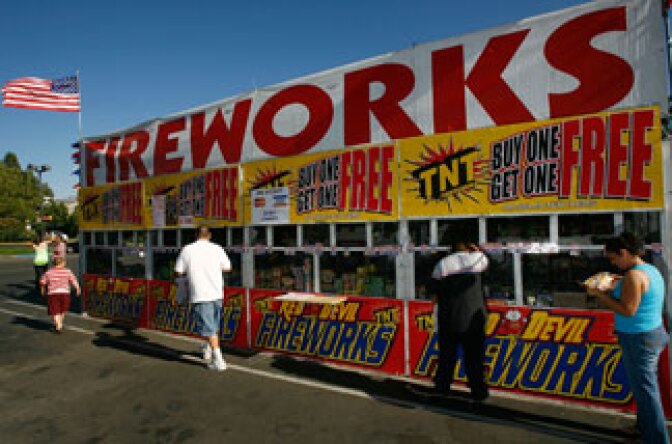 Customers buy fireworks for upcoming July 4th celebrations from the Rotary Club of Fillmore Sunrisers fireworks stand on June 30, 2008 in Fillmore, California.