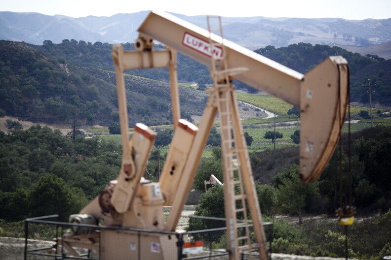 An oil well frames vineyards in Cat Canyon in Santa Barbara County. Measure P would ban some common practices used in oil fields, which would ultimately destroy the industry in Santa Barbara County, opponents say.