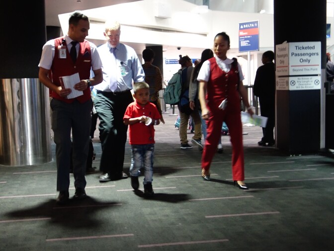                                Jefferson Jacinto Che Pop arrives with an escort of airline employees to meet his father July 14, 2018 after they were separated for 48 days. The boy, age 6, had been held at a shelter in the Bronx, New York since late May when he and his father, Hermelindo Che Coc