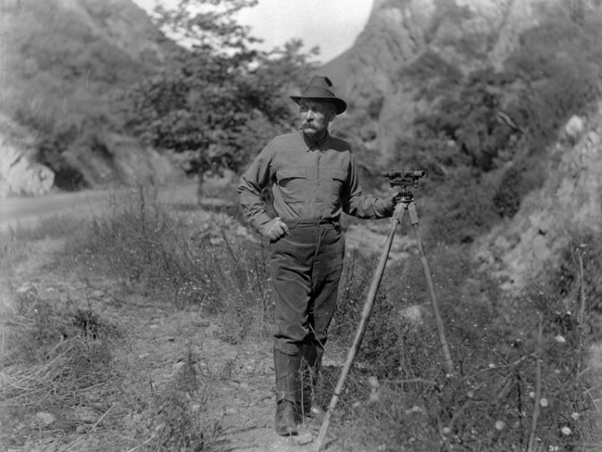 William Mulholland, the chief engineer for building of the Los Angeles Aqueduct, taken in the field, showing him with the surveying instrument whose use he knew so well.
