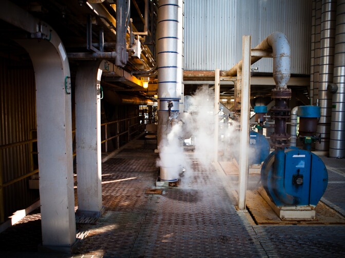 A cloud of steam vapor escapes from a pipe at the ASE Huntington Beach Power Plant.