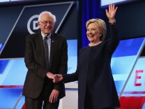 File: Bernie Sanders and Hillary Clinton appear at a presidential primary debate in Miami on March 9, 2016.