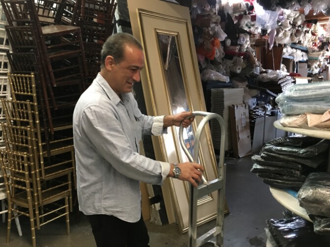 George Haratoonian at his business, a party rental company in Atwater. Haratoonian, an Armenian Christian, arrived as a refugee from Iran years ago. His brother's family was getting ready to come to the United States when the Trump administration's travel ban took effect. Although federal court orders have suspended the ban, the family has been unable to travel because their transit visas to Austria were canceled.