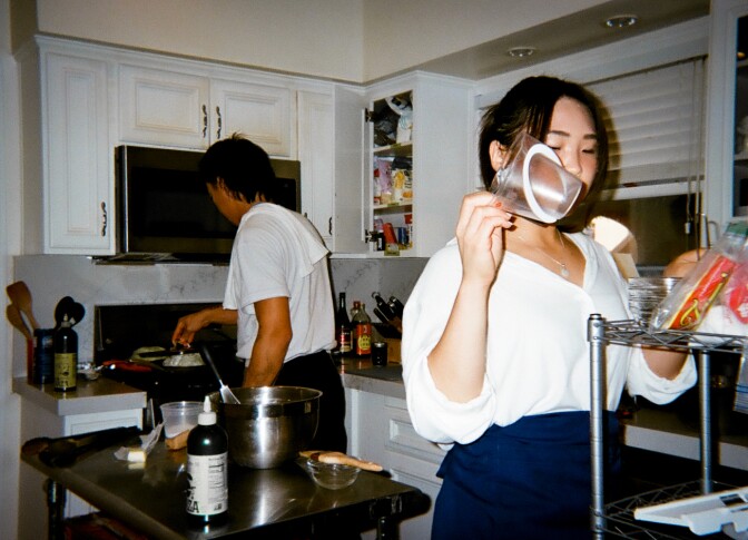 two people cooking in a home kitchen