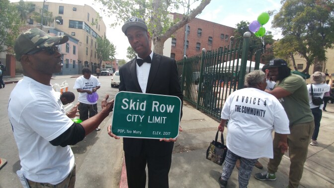 General Jeff, head organizer of the proposed Skid Row Neighborhood Council, greets voters as they line up outside San Julian Park on Thursday, April 6, 2017. 