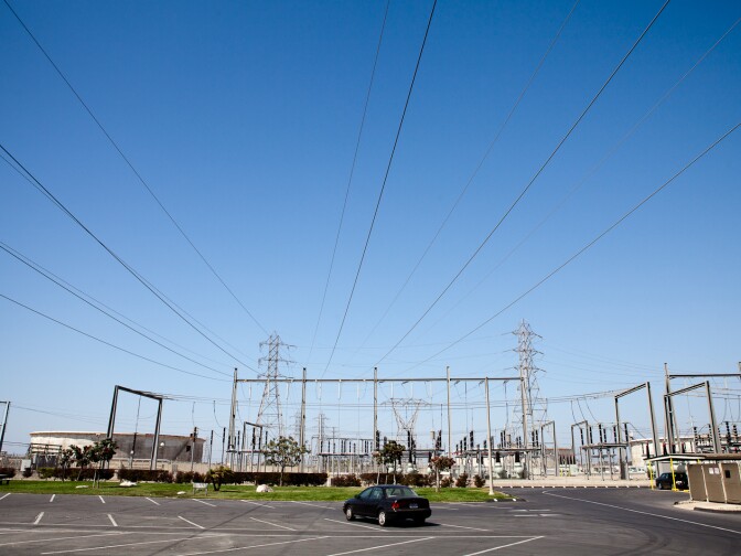 The main transmission lines pass over a parking lot at the AES power plant in Huntington Beach, CA.