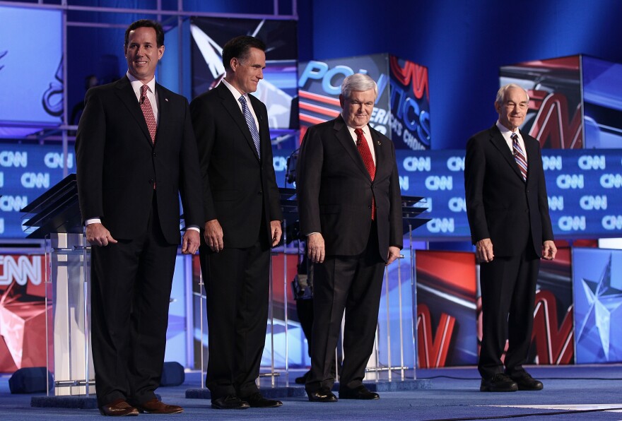 CHARLESTON, SC - JANUARY 19:  Republican presidential candidates (L-R) former U.S. Sen. Rick Santorum, former Massachusetts Gov. Mitt Romney, former Speaker of the House Newt Gingrich, and U.S. Rep. Ron Paul (R-TX) arrive on stage before a debate at the North Charleston Coliseum January 19, 2012 in Charleston, South Carolina. The debate, hosted by CNN and the Southern Republican Leadership Conference, is the final debate before South Carolina voters head to the polls for their primary January 21.  (Photo by Win McNamee/Getty Images)