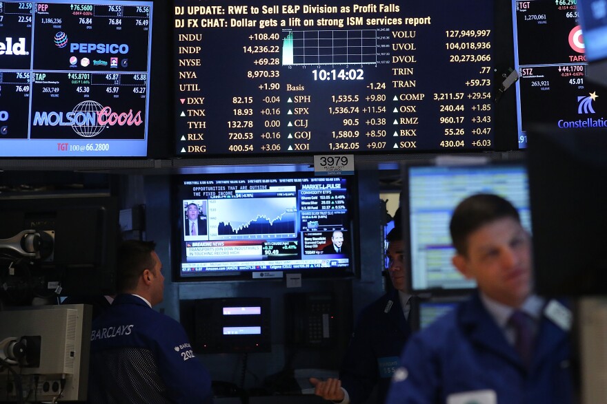 Traders work on the floor of The New York Stock Exchange on March 5, 2013 in New York City. Within the first few minutes of trading Tuesday, the Dow gained nearly 100 points, rising as high as 14,226.20, a new record high. 