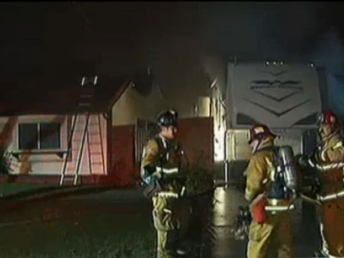 Firefighters work to extinguish flames near a home in Riverside County on February 28, 2013.